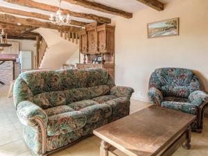 a living room with a couch and a table at Superb holiday home with pool in Cressensac