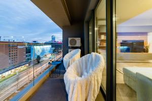 a balcony with chairs and a view of a city at North Twin1 - Aviatiei in Bucharest