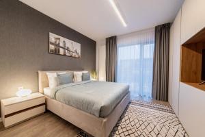 a bedroom with a bed and a large window at North Twin1 - Aviatiei in Bucharest