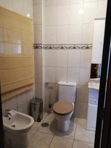 a bathroom with a toilet and a sink at Casinha de Nogueirinha in Macedo de Cavaleiros +19 photos