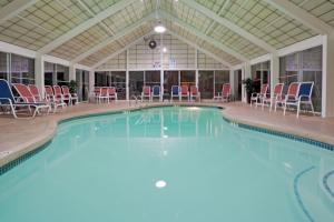 a large swimming pool with chairs in a building at Holiday Inn Portsmouth by IHG in Portsmouth