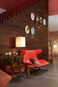 a living room filled with furniture and a clock at 25hours Hotel Zürich West in Zurich