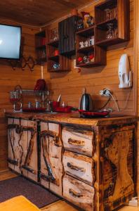 a kitchen with a wooden counter top in a room at Apartman Pustolov - Stara planina in Crni Vrh