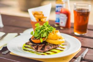 a plate with a steak sandwich on a table at The Castle Hotel in Llandovery