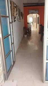 a hallway with a tile floor and an open door at Hotel El Puerto in Tolú