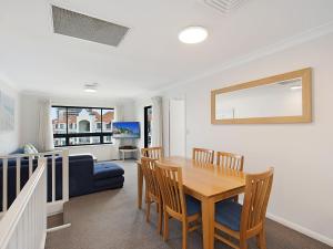 a dining room with a table and chairs and a couch at Calypso Plaza Resort Unit 417 in Gold Coast