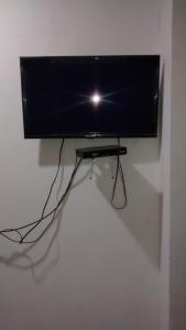 a flat screen tv hanging on a wall at Hotel El Puerto in Tolú +23 photos