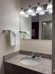 a bathroom with two sinks and a mirror at Americourt Hotel - Mountain City in Mountain City
