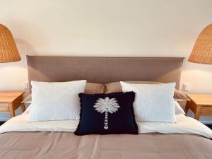 a bed with two pillows on it with two lamps at Bombora in Callala Beach