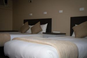 Postel nebo postele na pokoji v ubytování Astor Hotel Motel