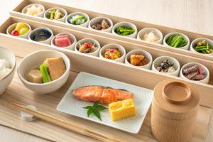 a tray with a plate of food and bowls of food at Hotel GrandBach Sendai in Sendai