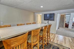 a large kitchen with a large bar with chairs at 33 West Washington Street in Ellicottville