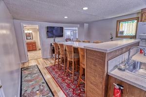 a kitchen with a counter and a bar with chairs at 33 West Washington Street in Ellicottville