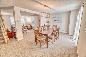 a dining room and living room with a table and chairs at 33 West Washington Street in Ellicottville