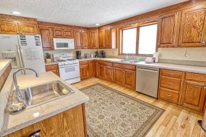 a large kitchen with wooden cabinets and a sink at 33 West Washington Street in Ellicottville