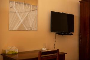a flat screen tv on the corner of a room at Sea View Beach Hotel in Zanzibar City
