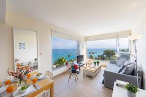 a living room with a view of the ocean at Eternity Apartment in Protaras