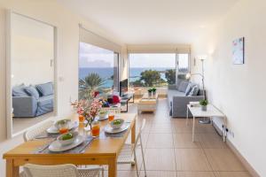 a dining room and living room with a table and chairs at Eternity Apartment in Protaras