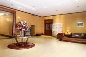 a lobby with a large bouquet of flowers on a table at Fushin Hotel - Tainan in Tainan