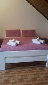 a large white bed with two pillows on it at Apartment Tonka's Terrace in Suđurađ