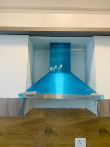 a glass cabinet with a blue inside of it at The Karma Square near India Expo Mart in Noida