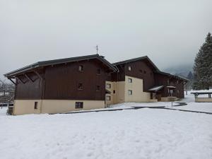 a large building with snow on the ground in front of it at studio Morillon village in Morillon
