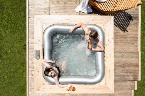 two young men in a swimming pool at Berry House in Vigolo Vattaro