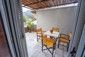 a balcony with a table and chairs on a patio at Kavousanos Apartments in Istron