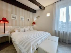 a bedroom with a white bed and a window at B&B Verona Centro in Verona