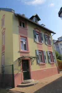 a yellow and orange house with a green door at Angela in Baden-Baden