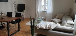 a living room with a couch and a table at Angela in Baden-Baden