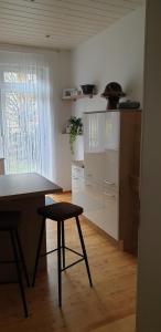 a kitchen with a table and a stool in a room at Angela in Baden-Baden