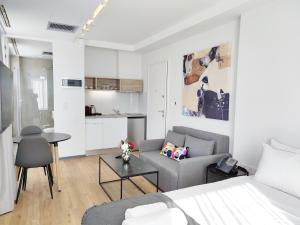 a living room with a bed and a couch and a table at Verde Apartments in Athens