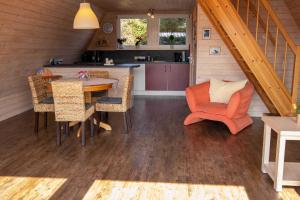 a kitchen and dining room with a table and chairs at Finnhütte Rabennest in Freest