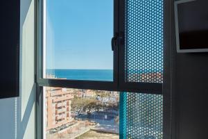 a view from a window of a building with a view of the ocean at Resa Patacona in Valencia
