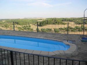 a swimming pool with a fence and a view at La Casa Laste in Casas de Esper