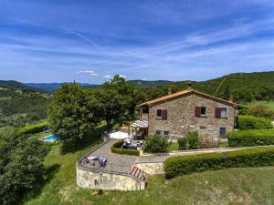 an external view of a stone house with a pool at Villa il Sole in Civitella in Val di Chiana