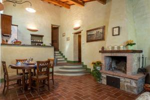 ein Wohnzimmer mit einem Tisch und einem Kamin in der Unterkunft Loreno in Roccalbegna