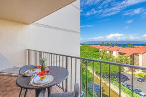 a table and chairs on a balcony with a view of the ocean at Kaanapali Shores Studio #742 in Lahaina