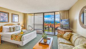 a living room with a bed and a balcony at Kaanapali Shores Studio #742 in Lahaina
