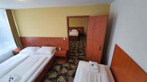 Postel nebo postele na pokoji v ubytování Hotel Der Tannenbaum