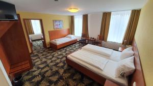 Postel nebo postele na pokoji v ubytování Hotel Der Tannenbaum
