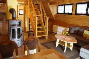 a living room with a staircase in a cabin at Ferienhaus auf der Kauperinsel in Burg