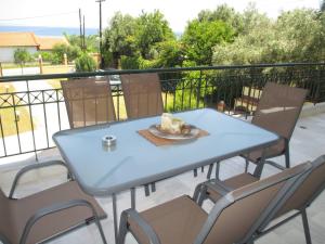 a blue table and chairs on a balcony at Seaside House 2 in Polychrono