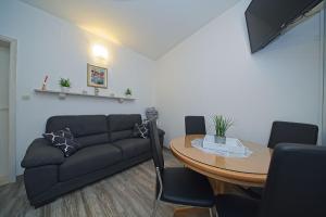 uma sala de estar com um sofá e uma mesa em Apartment Alva em Splitska