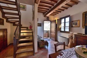 a hallway with a spiral staircase in a house at Il Balcone in Gaiole in Chianti