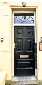 a black door with a window on a building at Large Luxury Apartment Blackpool in Blackpool