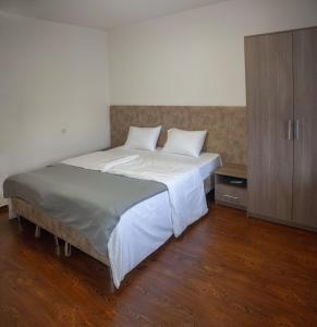 a bedroom with a large bed and a cabinet at Chayka Hotel Ingushetia in Armkhi