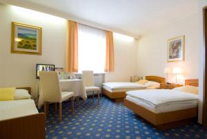 Postel nebo postele na pokoji v ubytování Hotel Biedermeier Hof