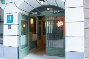 an entrance to a building with a green door at Hotel Alda Jolio Jaca in Jaca